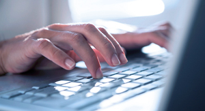 Person typing on keyboard