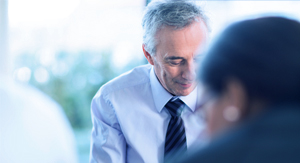 Man leaning over a computer